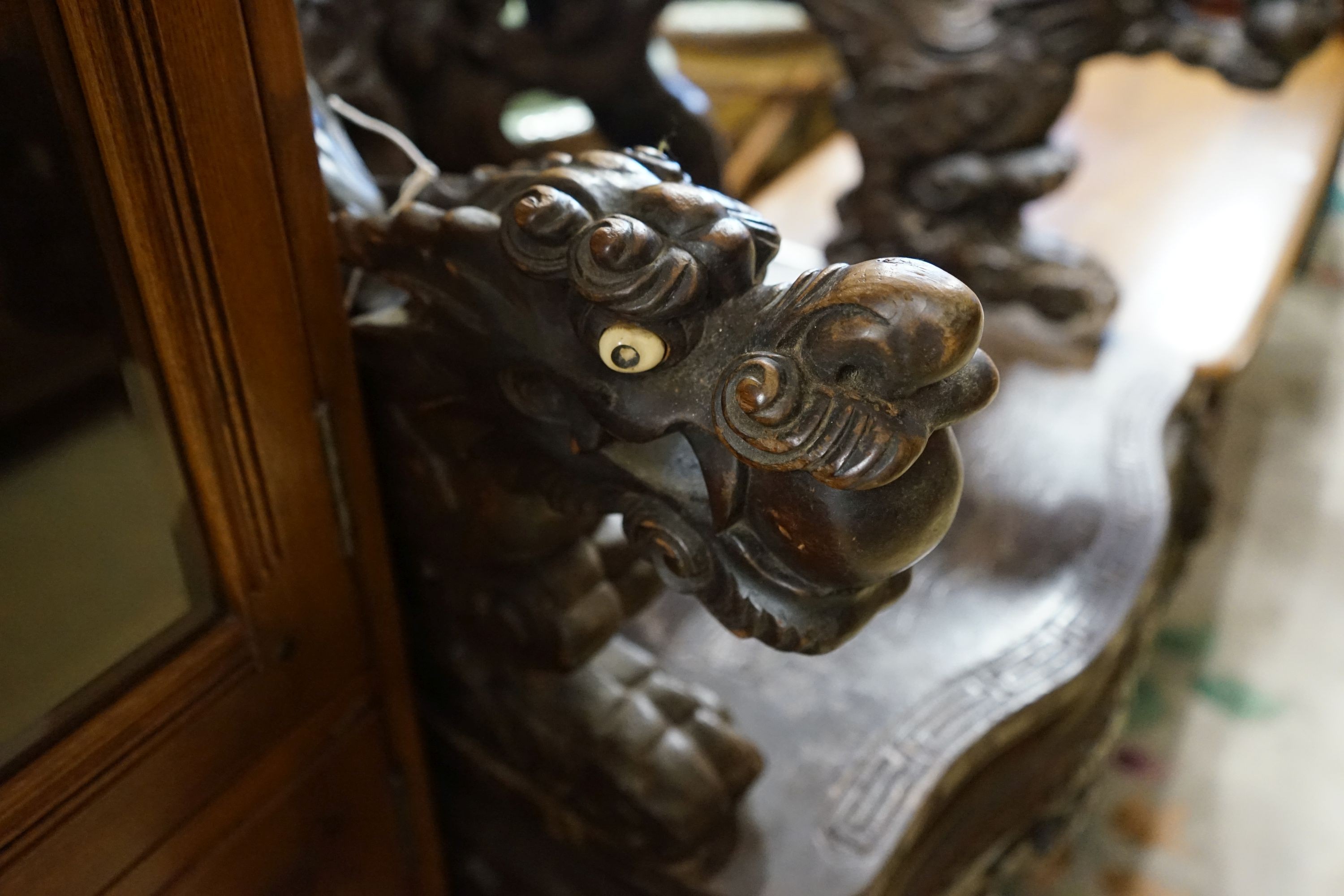 A Chinese carved hardwood 'dragon' elbow chair, width 68cm, depth 47cm, height 88cm